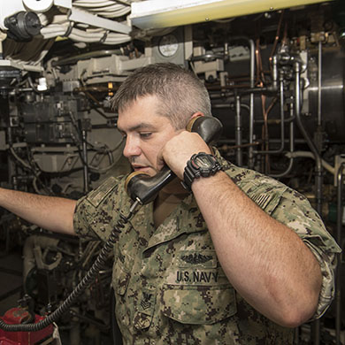 military person using a sound-powered telephone