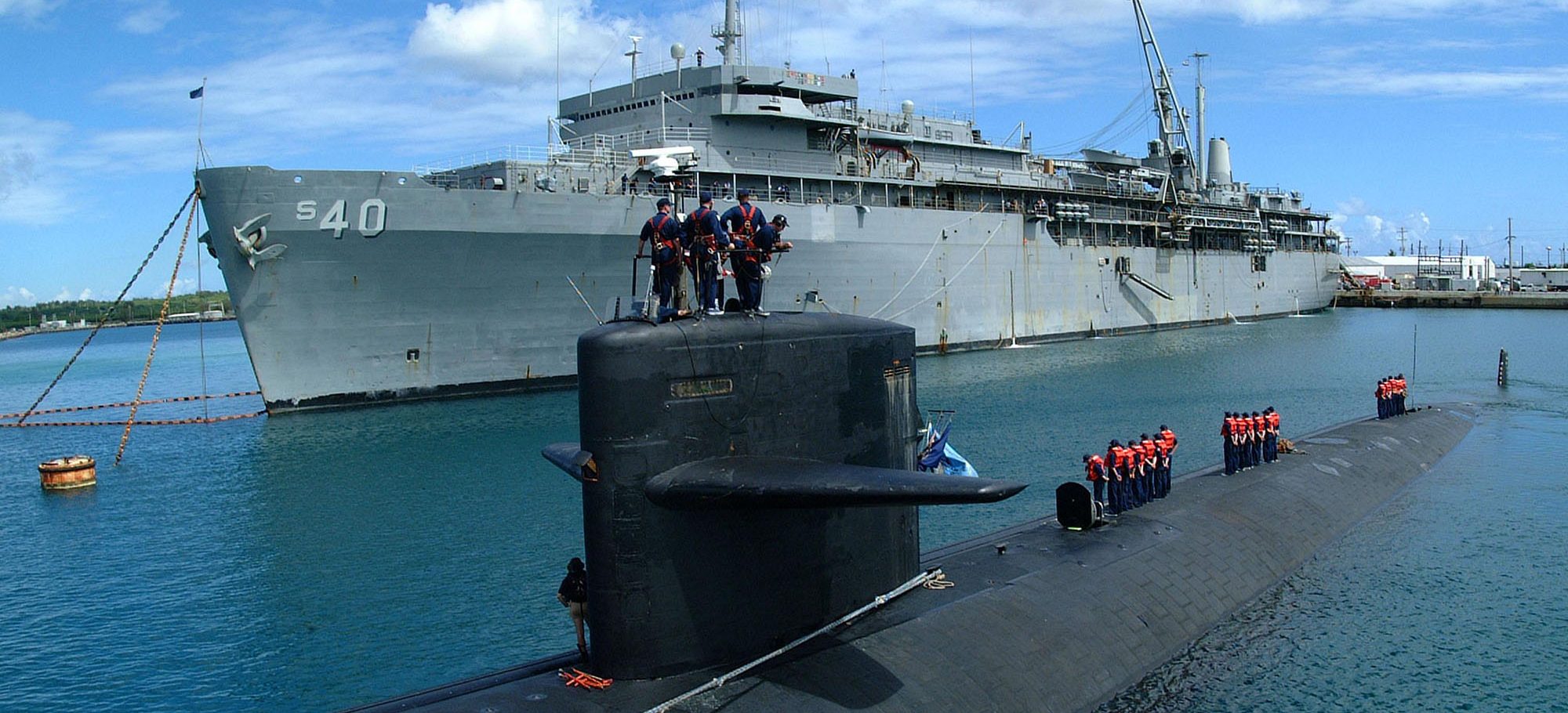 people standing on conning tower of submarine